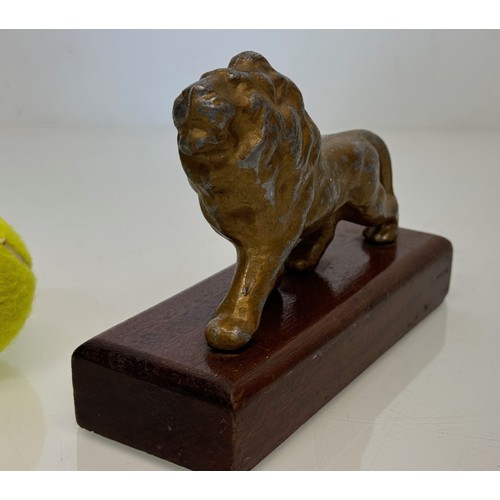 139 - A mounted cast figure of a Lion 18 cm long x 13 cm tall.

This lot is available for in-house shippin... 