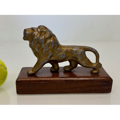 139 - A mounted cast figure of a Lion 18 cm long x 13 cm tall.

This lot is available for in-house shippin... 