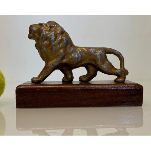 139 - A mounted cast figure of a Lion 18 cm long x 13 cm tall.

This lot is available for in-house shippin... 