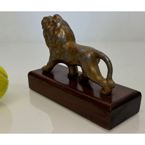 139 - A mounted cast figure of a Lion 18 cm long x 13 cm tall.

This lot is available for in-house shippin... 