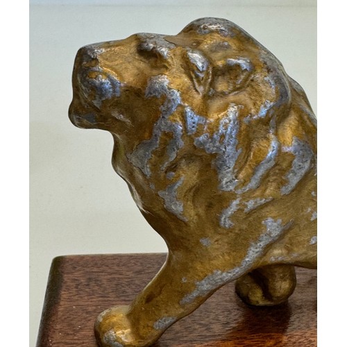 139 - A mounted cast figure of a Lion 18 cm long x 13 cm tall.

This lot is available for in-house shippin... 