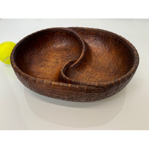 304 - Hand carved mid century wooden bowl of a yin and yang design, 31 cm x 25 cm x 7.5 cm.

This lot is a... 