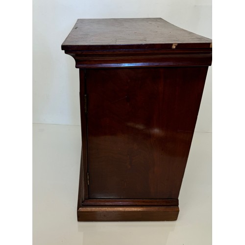 318 - Furniture, a mahogany collectors cabinet, the draws having multiple circular compartments within eac... 