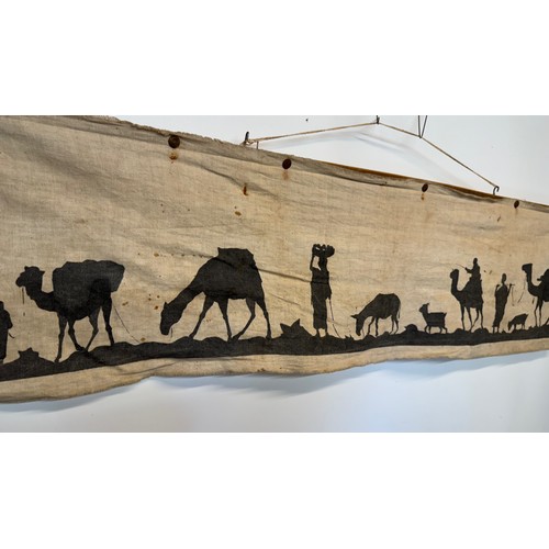 320 - Artwork, a Bedouin scene on linen, 109 cm x 27 cm.

This lot is available for in-house shipping