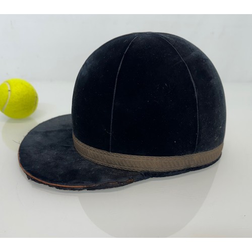 343 - Sporting equipment, a vintage deep blue velvet covered jockeys cap.

This lot is available for in-ho... 