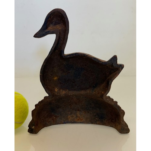 354 - An old cast iron door stop in the shape of a nesting duck. 17 cm wide x 20 cm tall.

This lot is ava... 