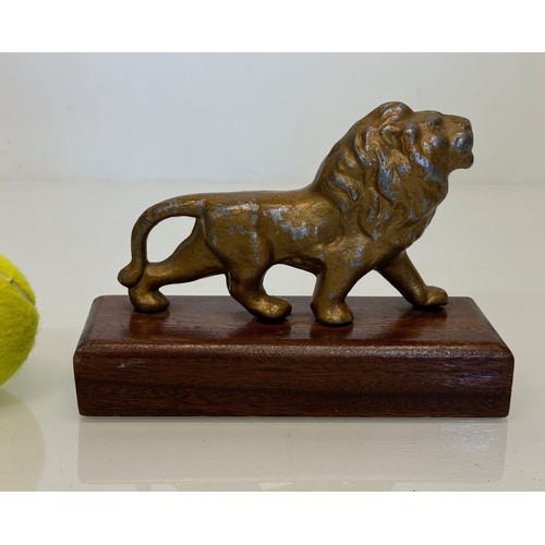 356 - A mounted cast figure of a Lion 18 cm long x 13 cm tall.

This lot is available for in-house shippin... 