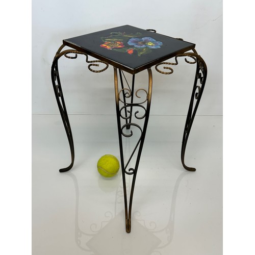 19 - Furniture, a kitsch tiled top wrought iron side table.

This lot is available for in-house shipping