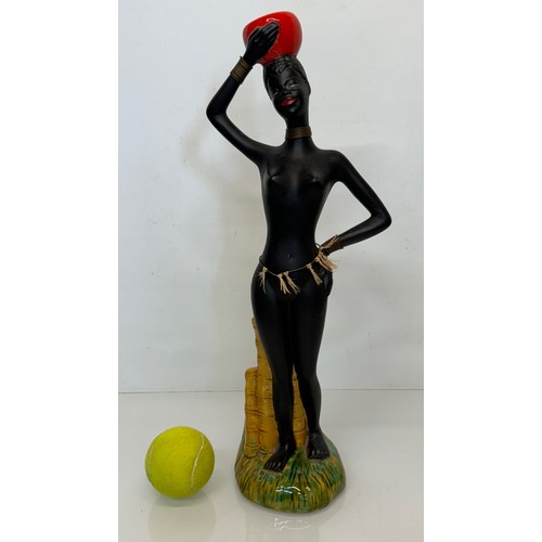 25 - Decorative figurine of a naked black female with a bowl balanced on her head. 45 cm tall.

This lot ... 