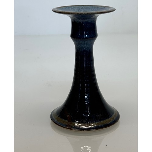 443 - Irish art pottery candle stick, signed to the base, 16 cm tall.

This lot is available for in-house ... 