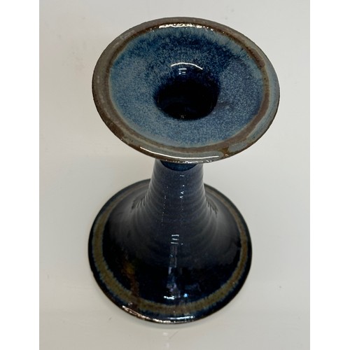 443 - Irish art pottery candle stick, signed to the base, 16 cm tall.

This lot is available for in-house ... 