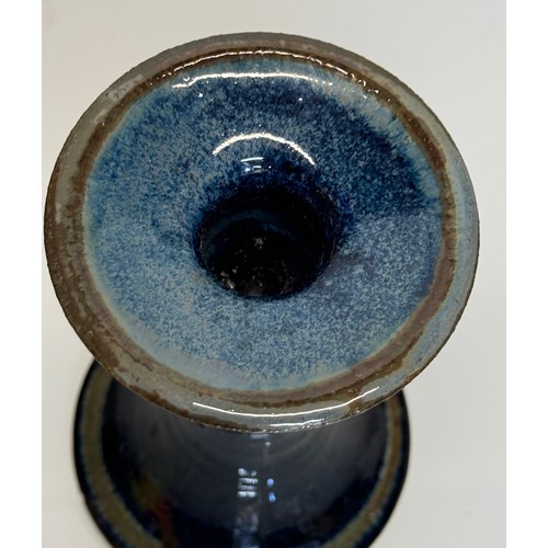 443 - Irish art pottery candle stick, signed to the base, 16 cm tall.

This lot is available for in-house ... 