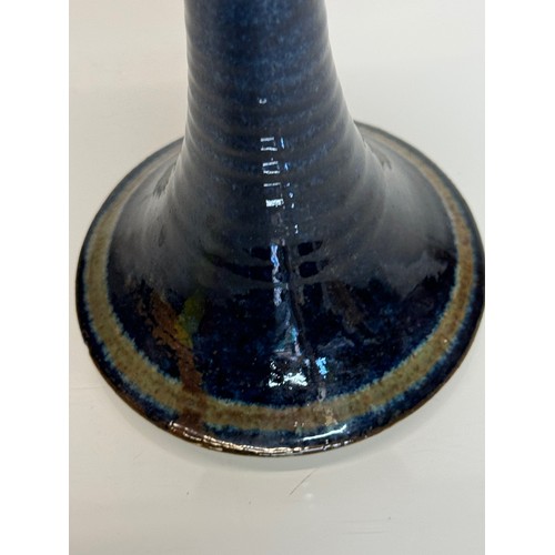 443 - Irish art pottery candle stick, signed to the base, 16 cm tall.

This lot is available for in-house ... 