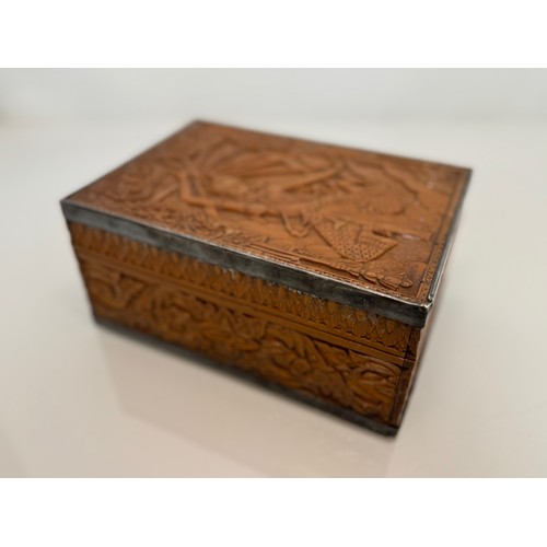 28 - Wooden box with hand carved decoration and white metal bindings, the lid has a dancer in front of a ... 