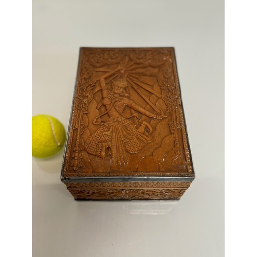 28 - Wooden box with hand carved decoration and white metal bindings, the lid has a dancer in front of a ... 