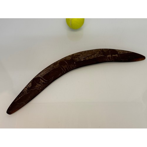 62 - Australian, Aboriginal, tribal art, a boomerang decorated with carvings of kangaroo’s, 45 cm wide.

... 