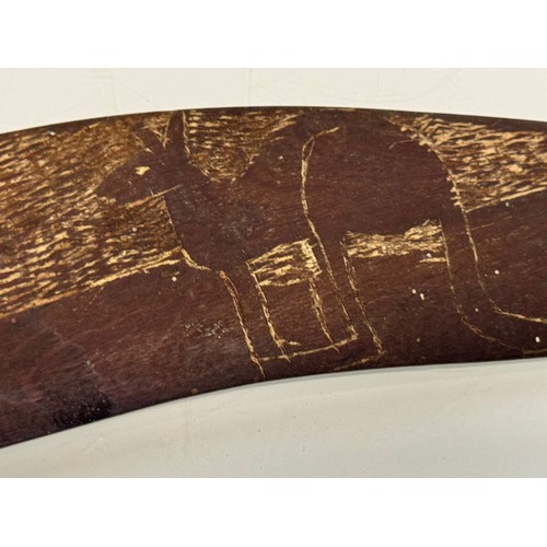 62 - Australian, Aboriginal, tribal art, a boomerang decorated with carvings of kangaroo’s, 45 cm wide.

... 