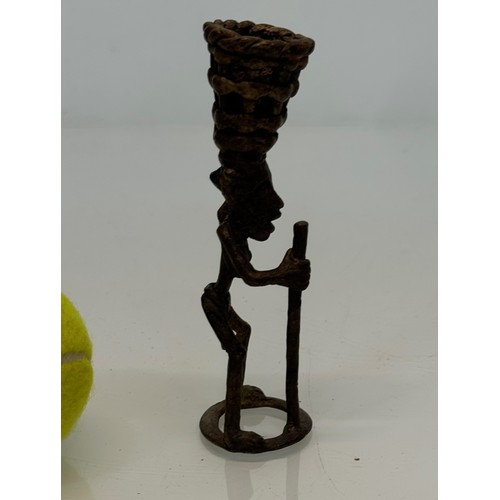 70 - Cast bronze tribal art figure with a basket on his head. 13 cm tall.

This lot is available for in-h... 