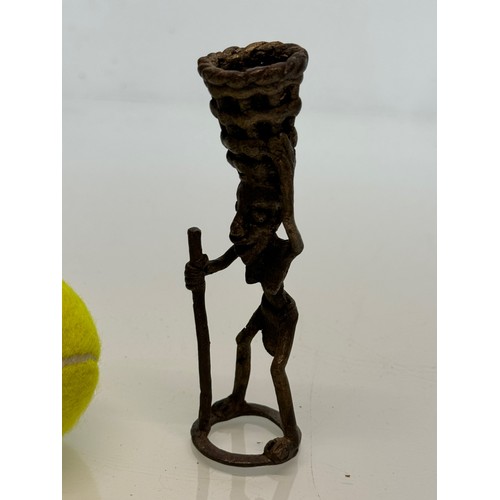 70 - Cast bronze tribal art figure with a basket on his head. 13 cm tall.

This lot is available for in-h... 