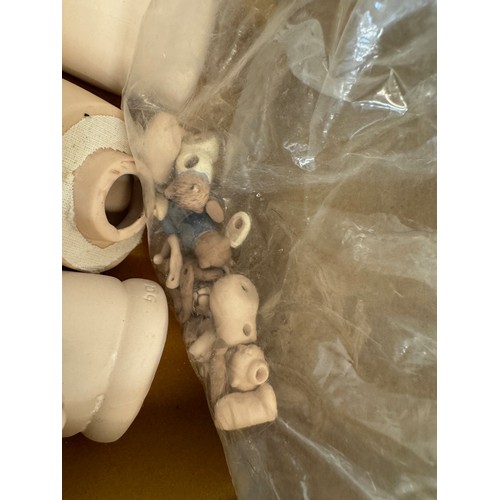 81 - Toys, a collection of doll parts, ceramic arms head and leg sections.

This lot is available for in-... 