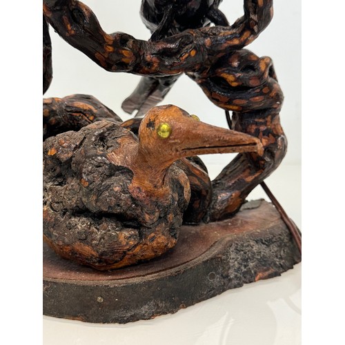 82 - Naive art, a French folk art lamp base from a carved vine section as bird and snake figures amongst ... 