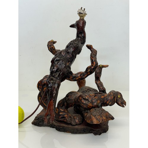 82 - Naive art, a French folk art lamp base from a carved vine section as bird and snake figures amongst ... 