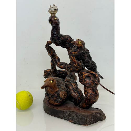 82 - Naive art, a French folk art lamp base from a carved vine section as bird and snake figures amongst ... 