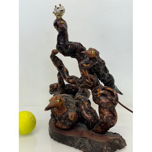 82 - Naive art, a French folk art lamp base from a carved vine section as bird and snake figures amongst ... 