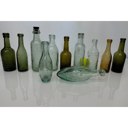 83 - A collection of dug glass drinks bottles, Wales, London, Essex, Cheshire, Bolton, Bedford, and Hitch... 