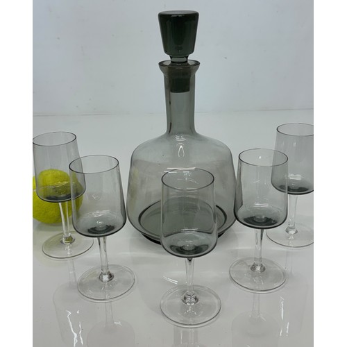 85 - Mid Century smoked glass decanter and glasses.

This lot is available for in-house shipping