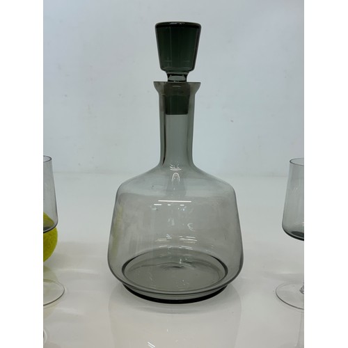 85 - Mid Century smoked glass decanter and glasses.

This lot is available for in-house shipping