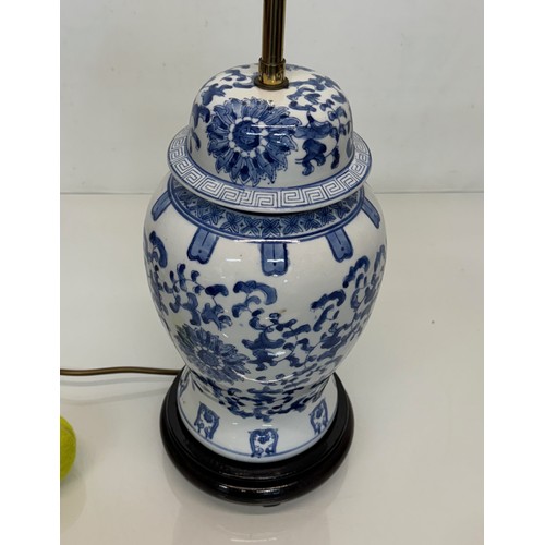 98 - Oriental design lamp with a blue and white glazed base decorated with flowers. 44  cm high.

This lo... 