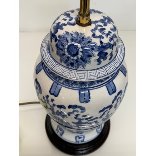 98 - Oriental design lamp with a blue and white glazed base decorated with flowers. 44  cm high.

This lo... 