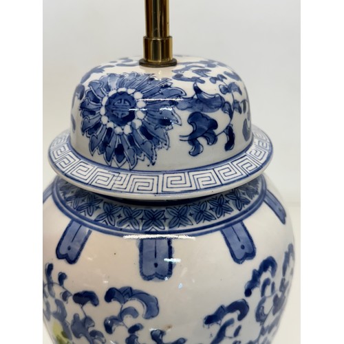 98 - Oriental design lamp with a blue and white glazed base decorated with flowers. 44  cm high.

This lo... 