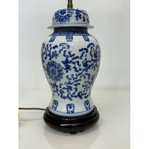 98 - Oriental design lamp with a blue and white glazed base decorated with flowers. 44  cm high.

This lo... 