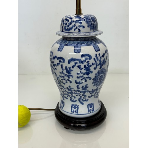 98 - Oriental design lamp with a blue and white glazed base decorated with flowers. 44  cm high.

This lo... 