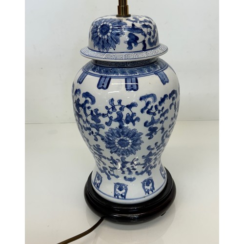 98 - Oriental design lamp with a blue and white glazed base decorated with flowers. 44  cm high.

This lo... 