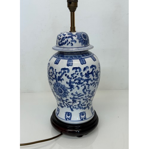 98 - Oriental design lamp with a blue and white glazed base decorated with flowers. 44  cm high.

This lo... 