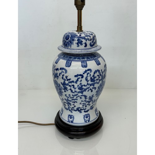 98 - Oriental design lamp with a blue and white glazed base decorated with flowers. 44  cm high.

This lo... 