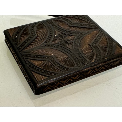 100 - A carved wooden card case, hand decorated on all sides, 10 cm x 8.5 cm.

This lot is available for i... 