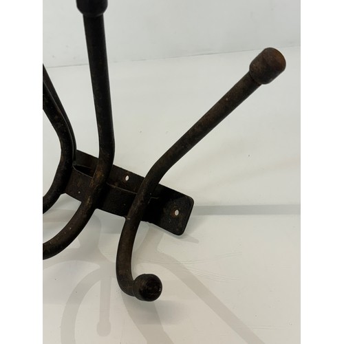 103 - Architectural salvage, a wrought iron coat peg, 32 cm wide x 20 cm.

This lot is available for in-ho... 