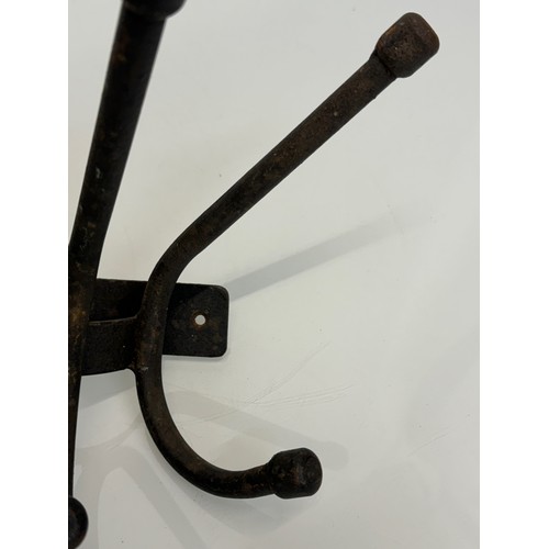 103 - Architectural salvage, a wrought iron coat peg, 32 cm wide x 20 cm.

This lot is available for in-ho... 