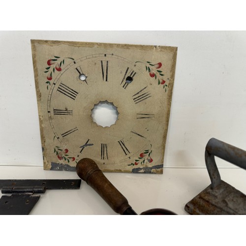 105 - Mixed lot, Clock face, tools, an iron and door fittings.

This lot is available for in-house shippin... 