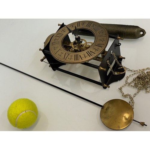 107 - Wall clock with an open case showing the movement. Pendulum is 32 cm long. Dial is 14 cm in diameter... 