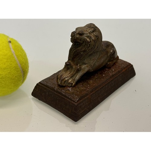 109 - Cast figure of a lion on a plinth. 12 cm x 7.5 cm high.

This lot is available for in-house shipping