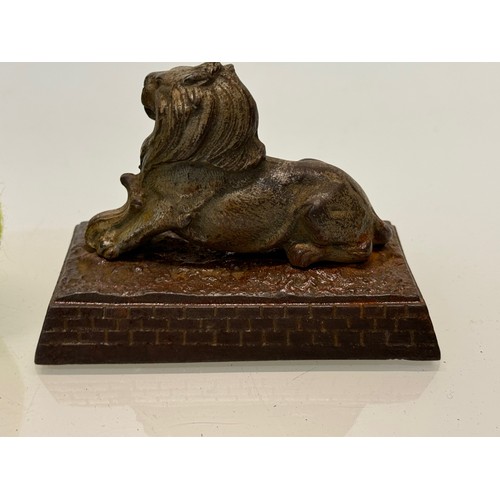 109 - Cast figure of a lion on a plinth. 12 cm x 7.5 cm high.

This lot is available for in-house shipping