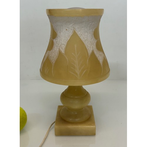 110 - A Carved stone table lamp, with hand carved floral and leaf designs to the shade section. 29 cm tall... 