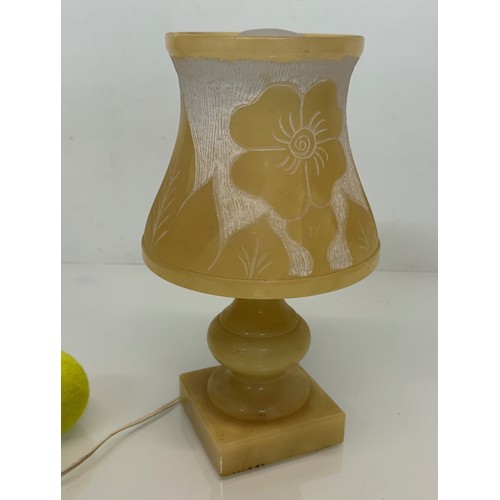 110 - A Carved stone table lamp, with hand carved floral and leaf designs to the shade section. 29 cm tall... 