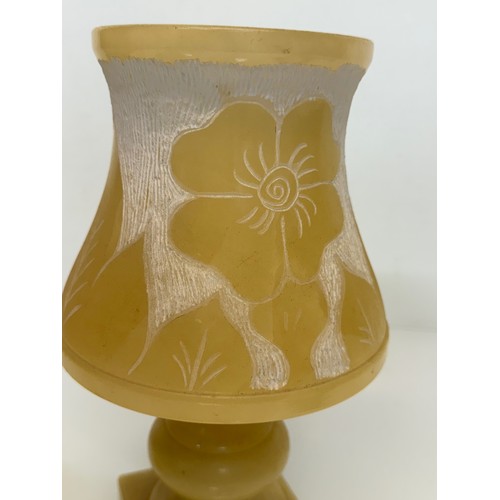 110 - A Carved stone table lamp, with hand carved floral and leaf designs to the shade section. 29 cm tall... 