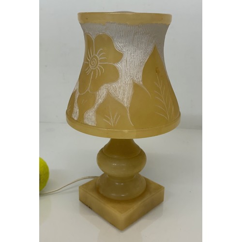 110 - A Carved stone table lamp, with hand carved floral and leaf designs to the shade section. 29 cm tall... 